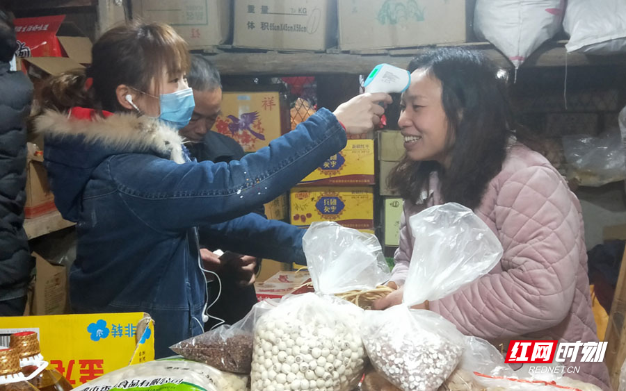 1月23日，武冈市农产品市场管理所会同卫生防疫部门对市场内的从业人员进行了体温测量，做好新型冠状病毒感染的肺炎疫情防控工作，图为检测照片。(杨良晖 摄影 报道)