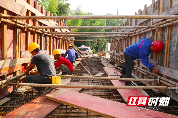 毛俊水库新田灌区干渠二标段施工现场，工人们正在进行渡槽的建设施工。